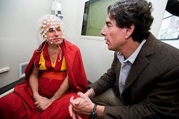 Dr. Richard J. Davidson speaking with a monk wearing an EEG net in the laboratory